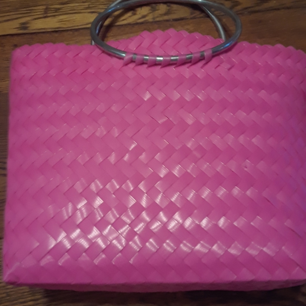 Hot pink plastic tote with chrome handles.